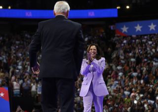 kamala harris wearing a lilac suit at a rally