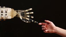 A robotic hand interacts with a person 