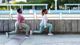 Two women performing lunges outdoors