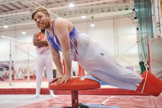 Rob Beckett flexes his muscles as he gives gymnastics a go.