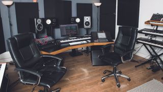 Recording studio with computer and two empty chairs