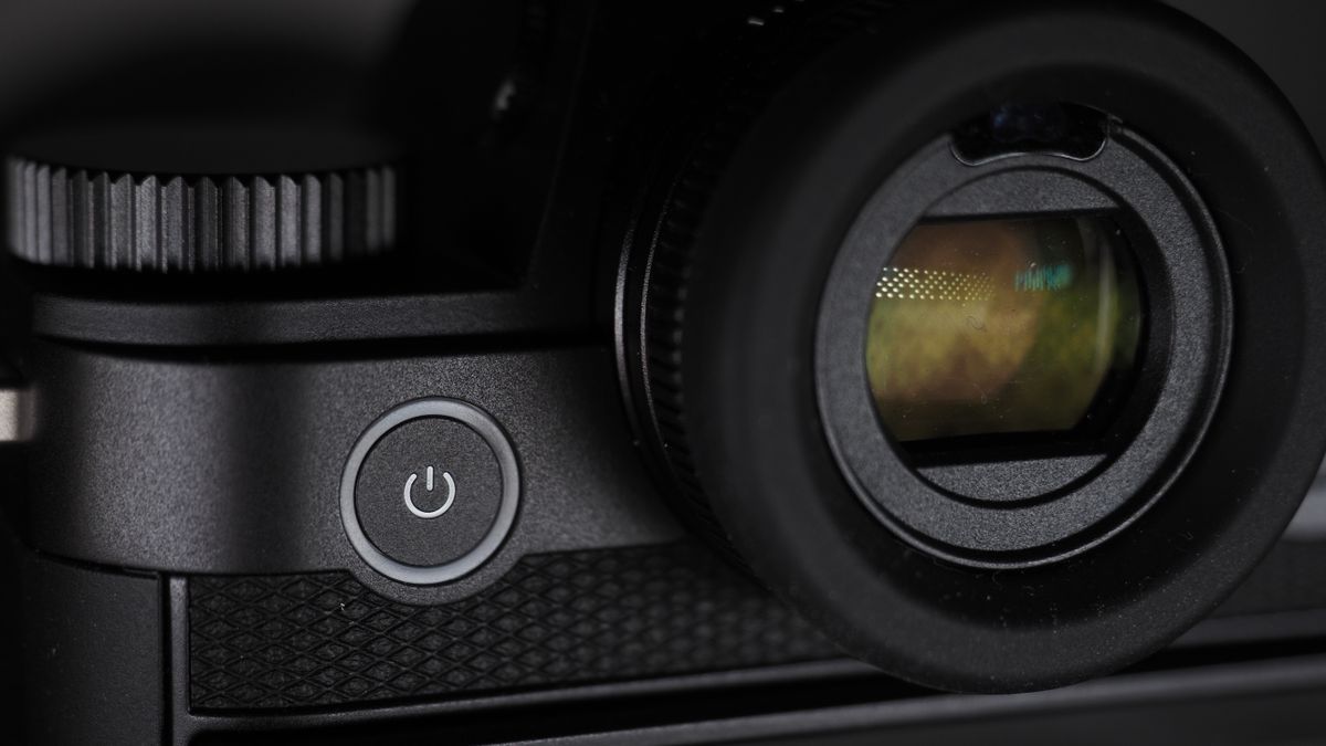 Leica SL3-S on a wooden surface with moody lighting