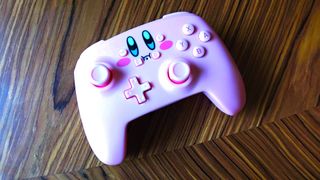 PowerA Kirby controller on wood surface