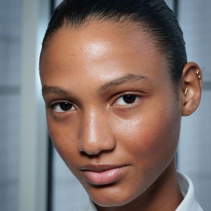 headshot of model backstage with glowy skin