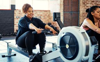 A woman uses a rowing machine