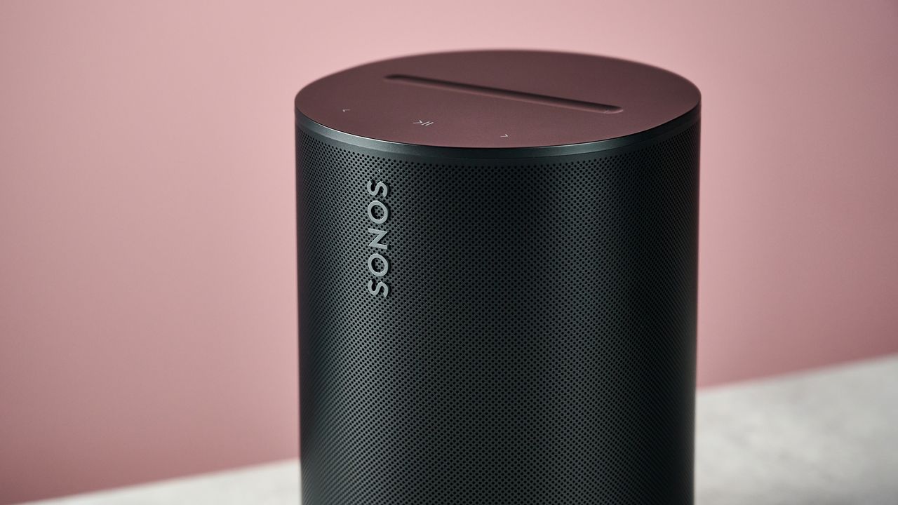 A closeup of the Sonos Era 100 SL, showing the Sonos logo on the front and the buttons on top.