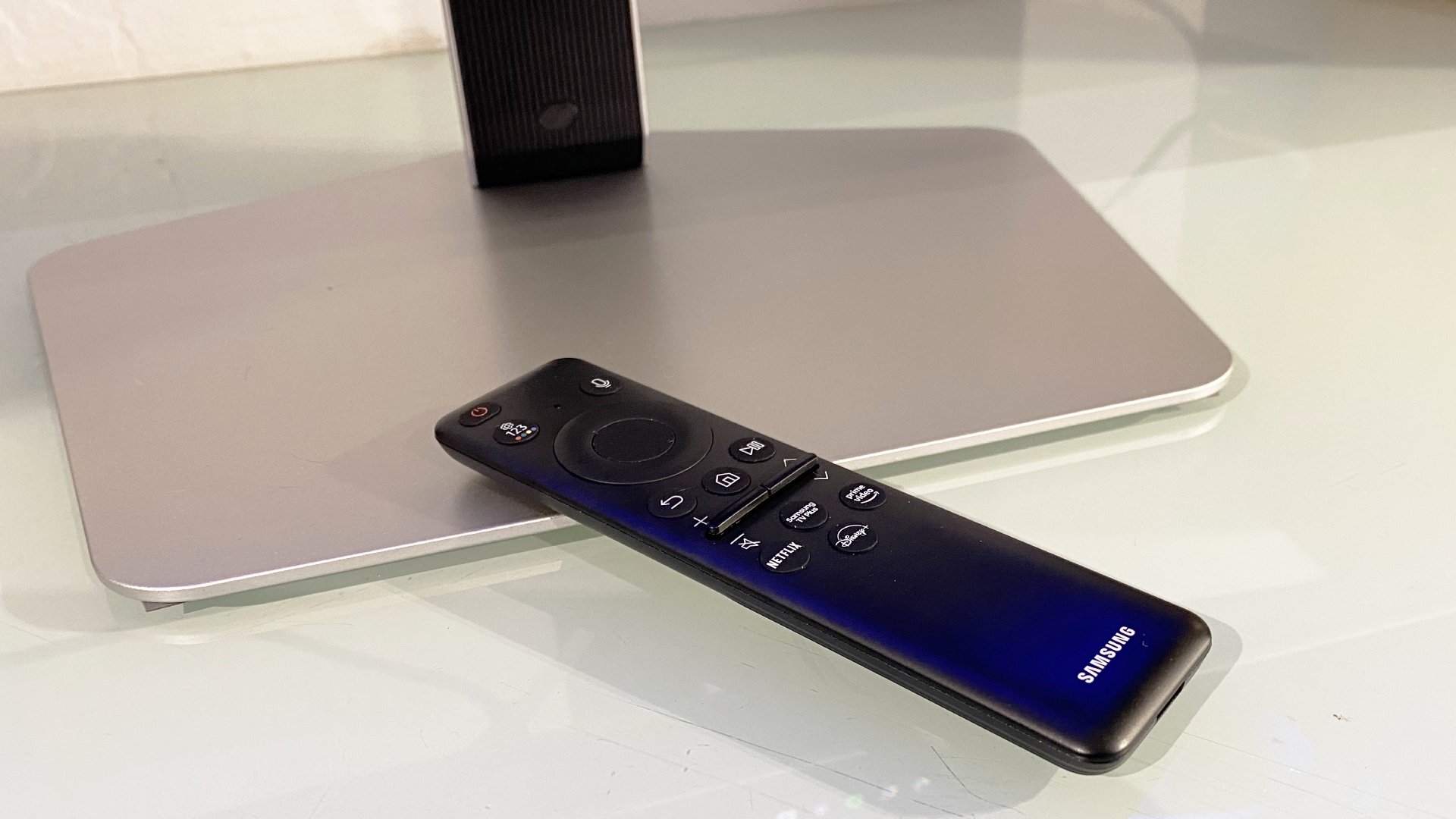 The Samsung Odyssey G8 OLED G80SD monitor's small remote control