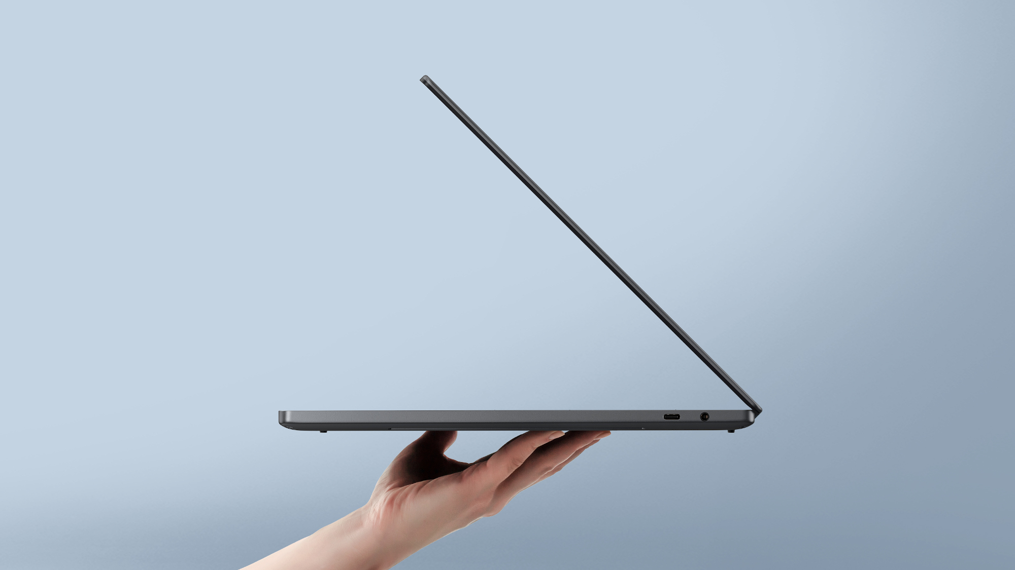 Dell XPS 14 2026 side profile view with laptop half-open, showing thin chassis
