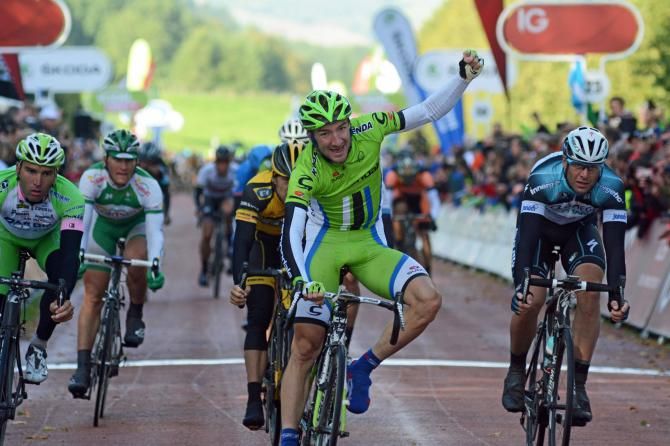 Elia Viviani won stage one of the Tour of Britain after a day of heavy rain and strong winds.