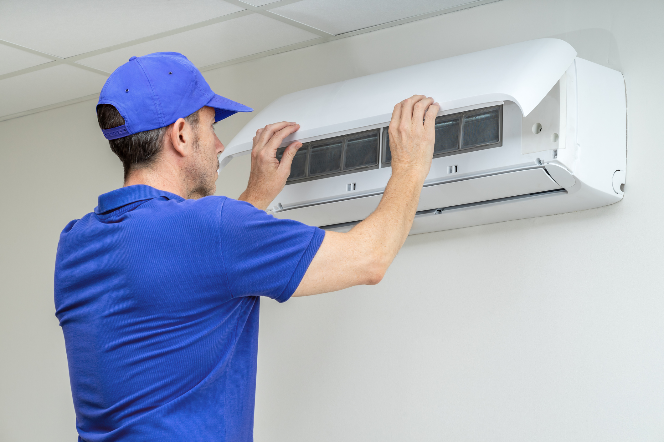 Engineer installing air conditioning 
