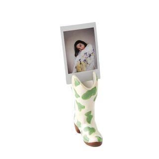 A cowboy boot photo holder with a picture in it