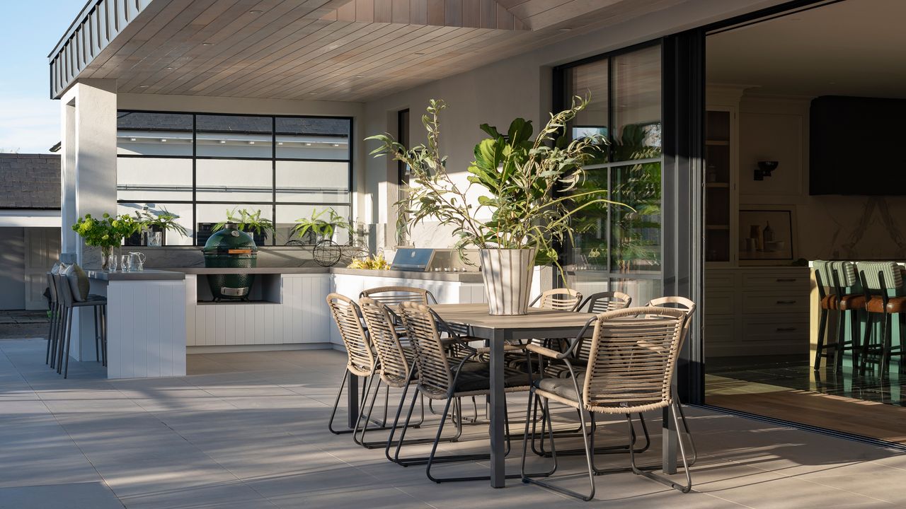 outdoor kitchen dining area with table and chairs