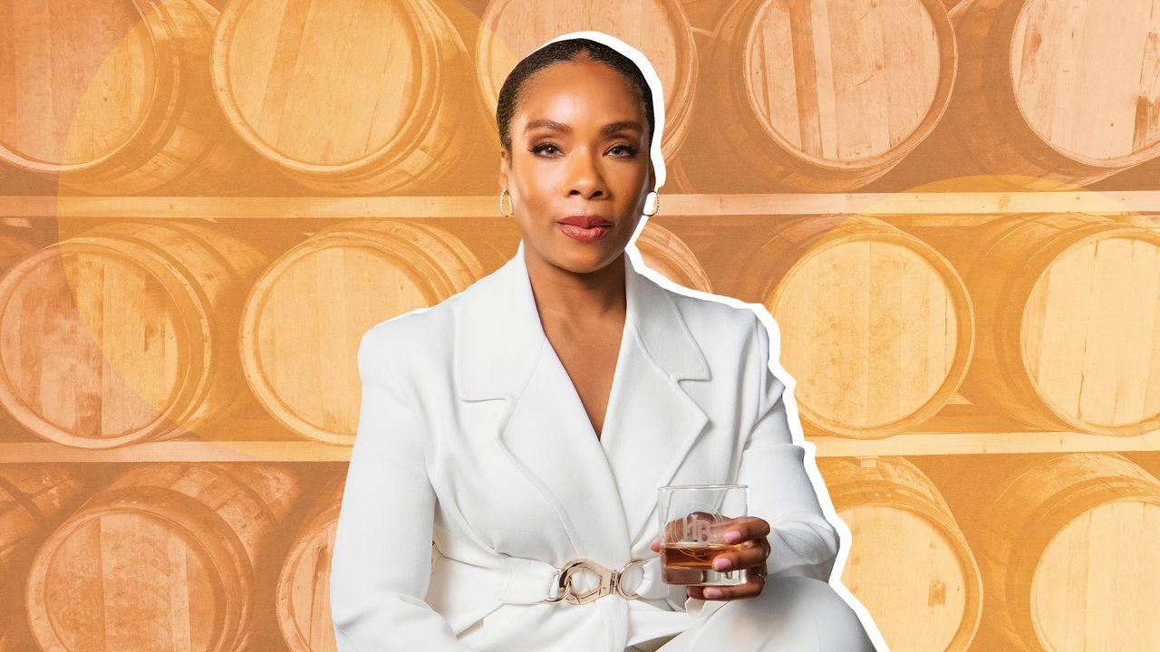 Woman in a white business suit holding a glass of whiskey