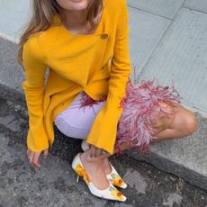 Sara Walker in an orange Proenza Schouler top and 16arlington feather skirt