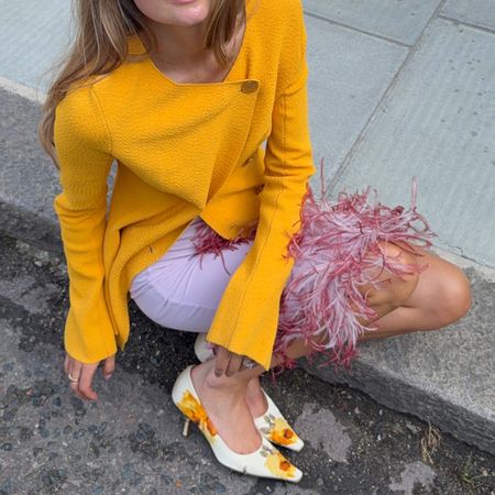 Sara Walker in an orange Proenza Schouler top and 16arlington feather skirt