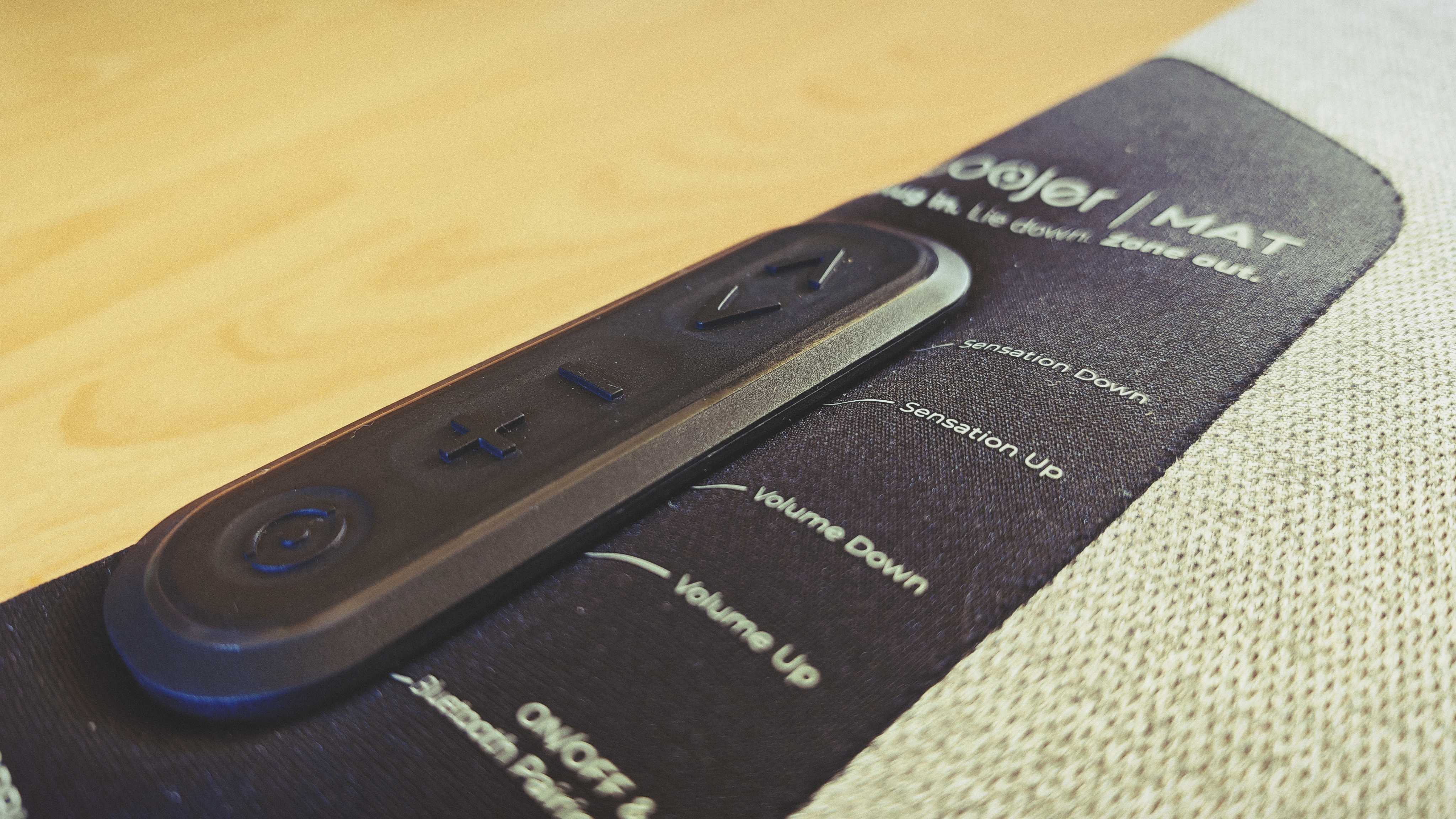 A Woojer Mat on a wooden floor