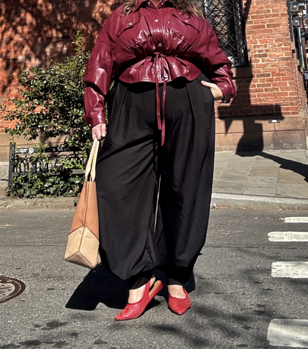 Sarah Chiwaya styles red Andr&amp;eacute; Assous mules with a cinched bomber and balloon pants