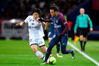 Paris Saint-Germain's Brazilian forward Neymar (R) outruns Dijon's South-Korean midfielder Chang-Hoon Kwon during the French L1 football match between Paris Saint-German and Dijon on January 17, 2018 at the Parc des Princes stadium in Paris.