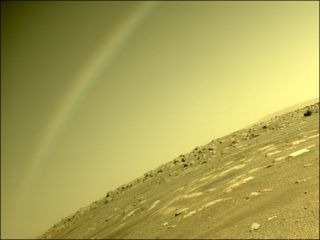 NASA's Perseverance Mars rover acquired this image of the area in back of it using its Rear Left Hazard Avoidance Camera on April 4, 2021. The “rainbow” is just a lens flare, agency officials said.