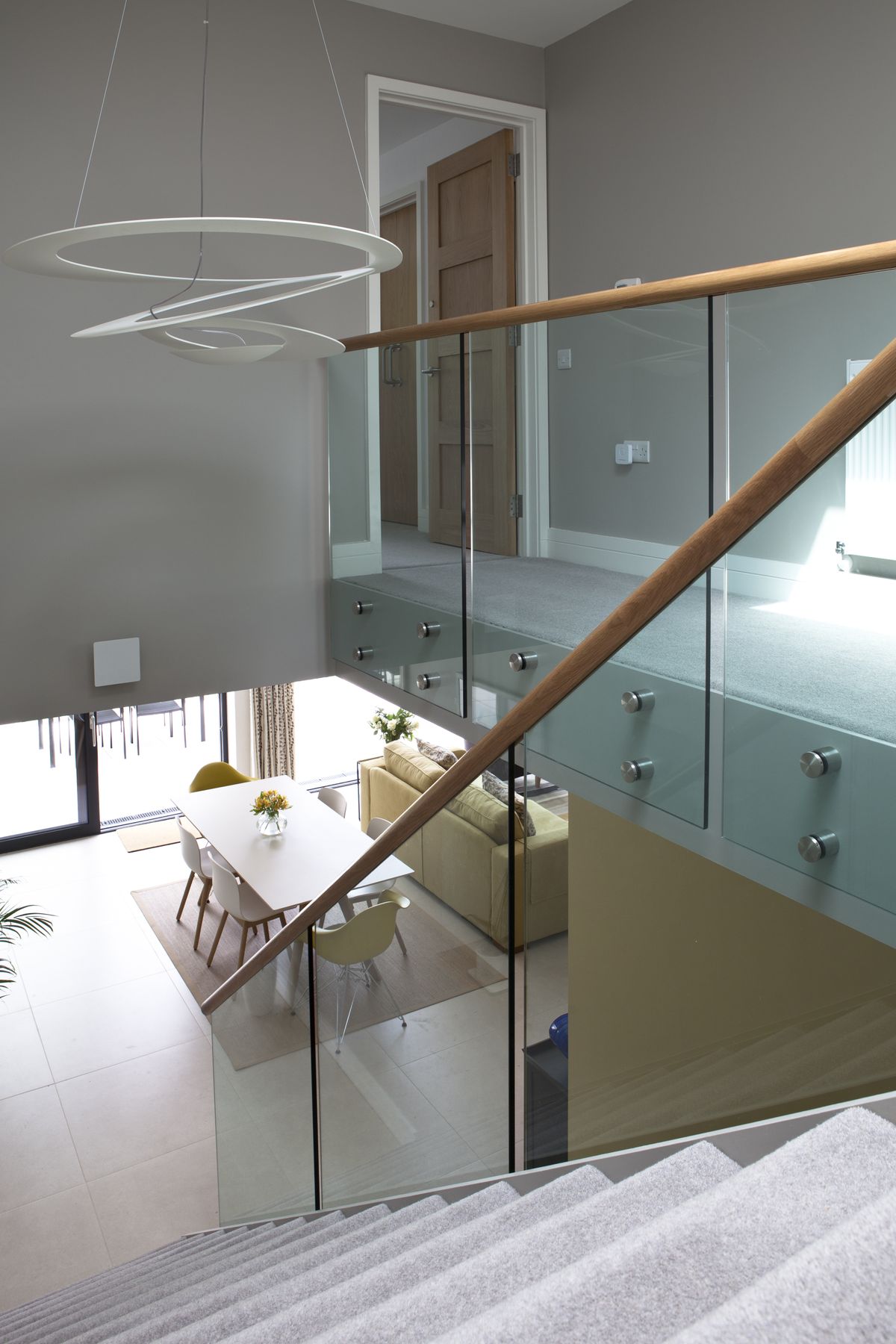 The view from the landing (top) emphasises the build&rsquo;s light and airy feel, with the glass balustrade allowing natural light to make the maximum impact.