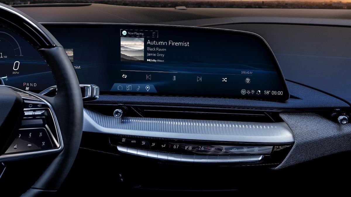 Cadillac dashboard showing an infotainment screen and Dolby Atmos music playing