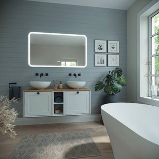 Blue bathroom with double sinks and white vanity unit