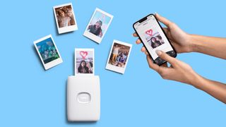 The Instax Mini Link 2 printer being used to print pictures on instant film