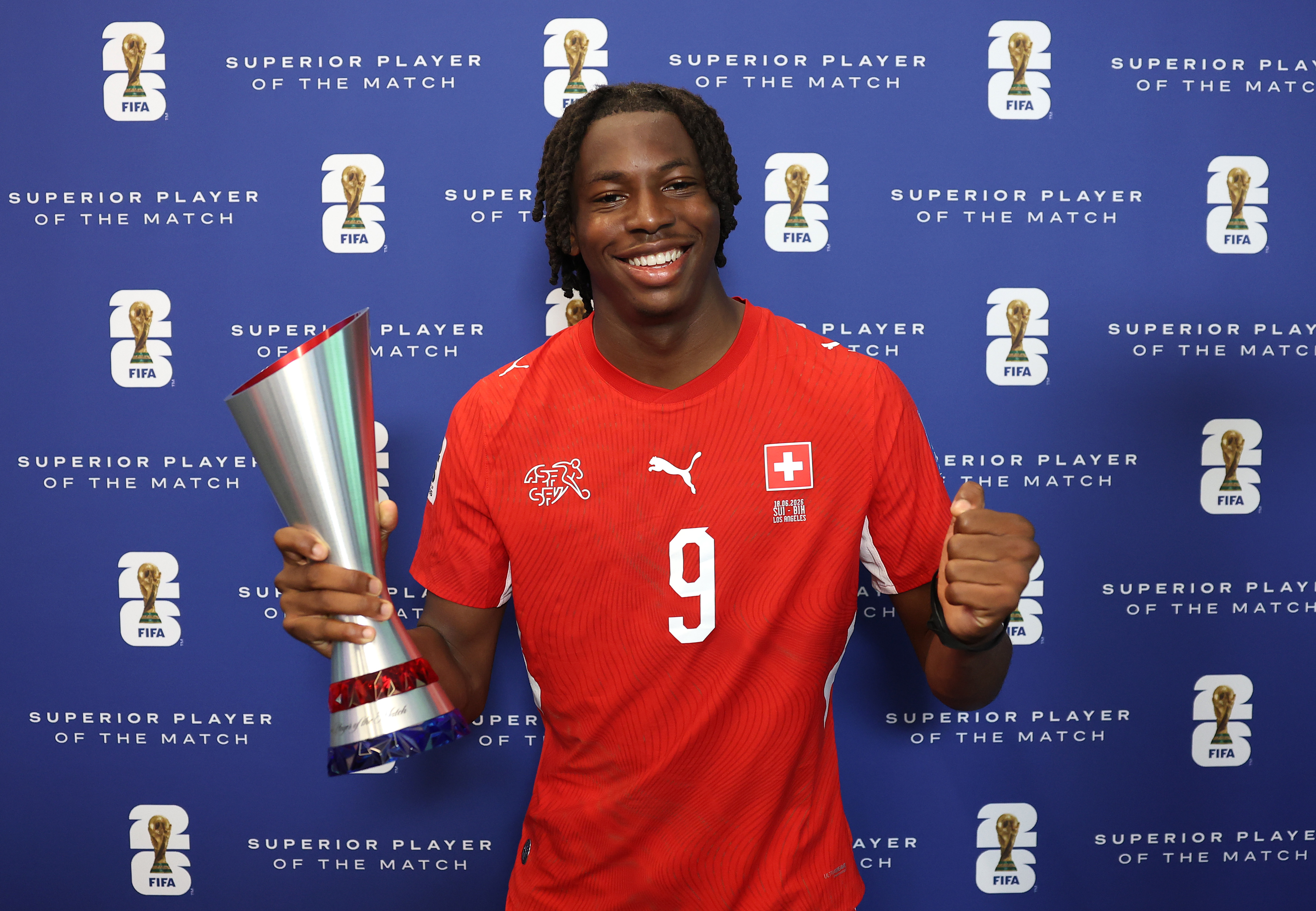 INGLEWOOD, CALIFORNIA - JUNE 18: Johan Manzambi #9 of Switzerland poses with the Superior Player of the Match Trophy during the FIFA World Cup 2026 Group B match between Switzerland and Bosnia and Herzegovina at Los Angeles Stadium on June 18, 2026 in Inglewood, California. (Photo by Matt McNulty - FIFA/FIFA via Getty Images)