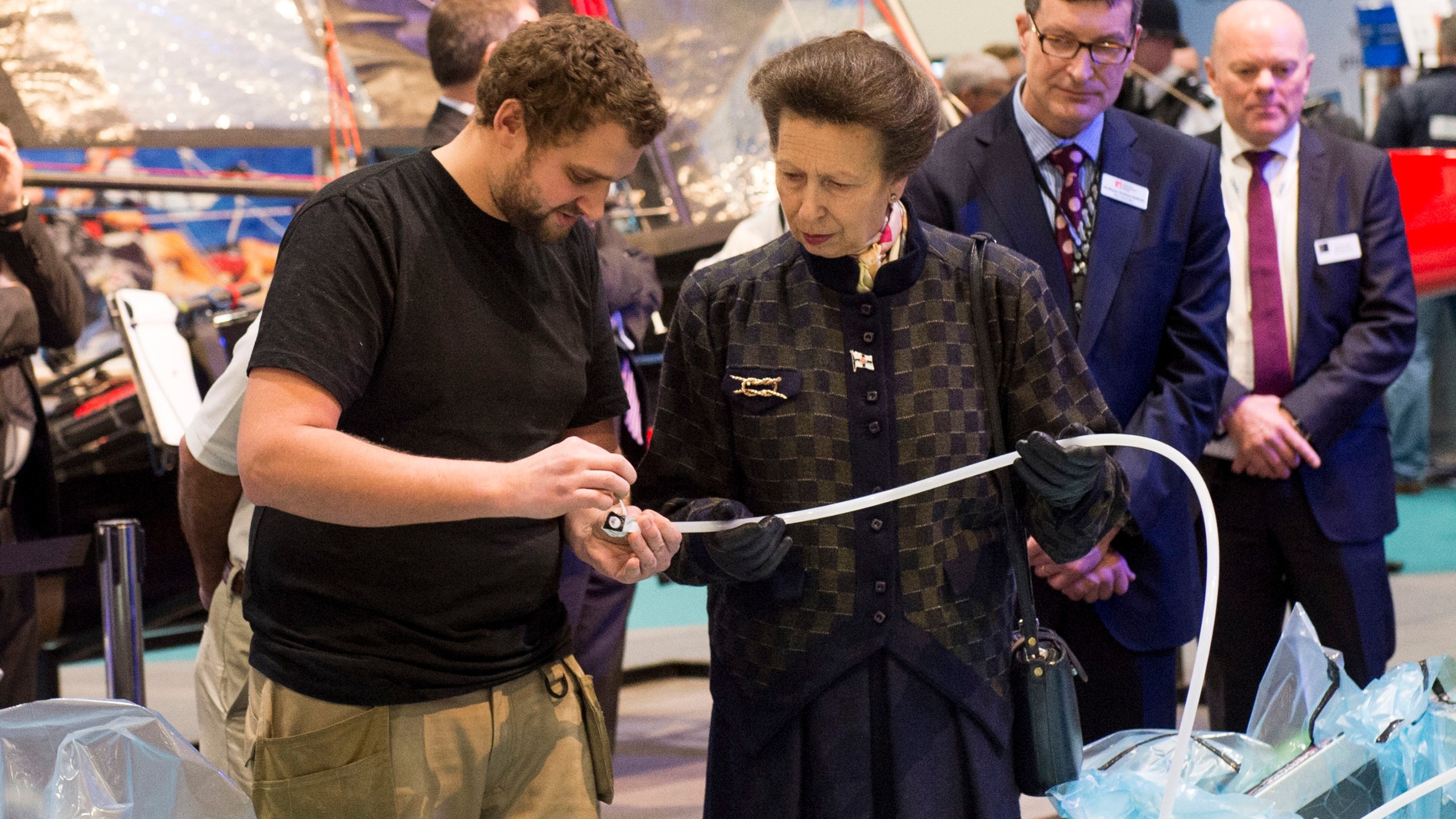 Princess Anne, Princess Royal helps to build a boat by injecting resin into a frame during a visit to the London Boat Show at ExCel on January 14, 2015