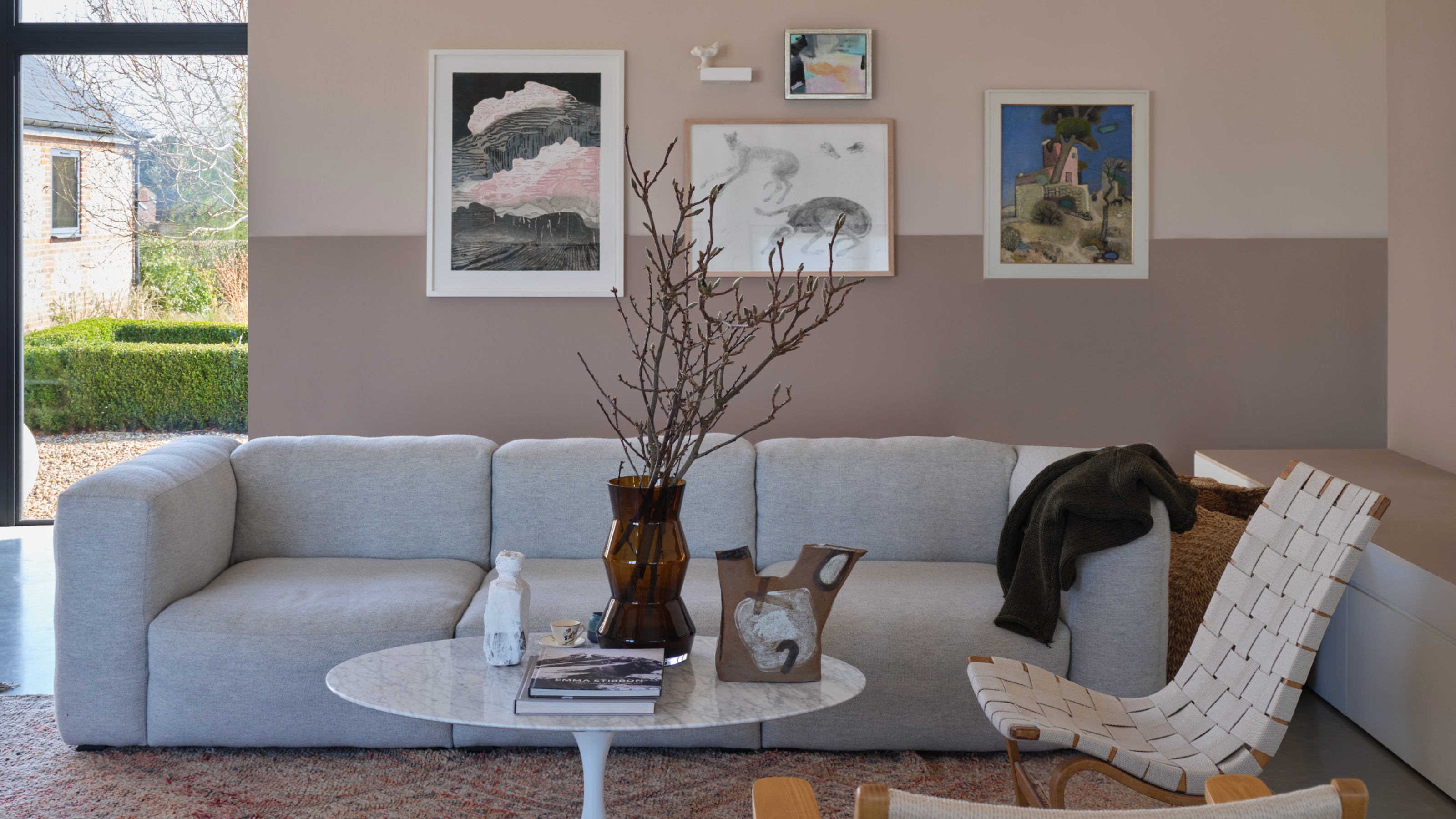 A living room with a modular sofa and a two-tone feature wall painted in Dead Salmon and Scallop