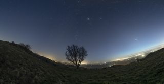 photo of the night sky showing seven planets aligned across the sky in a planetary parade.