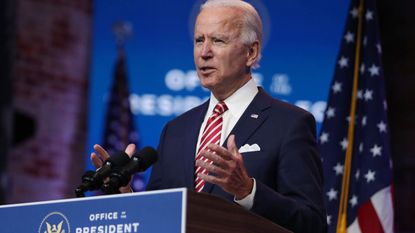 President Joe Biden standing at a lectern delivering remarks about the U.S. economy during a press briefing