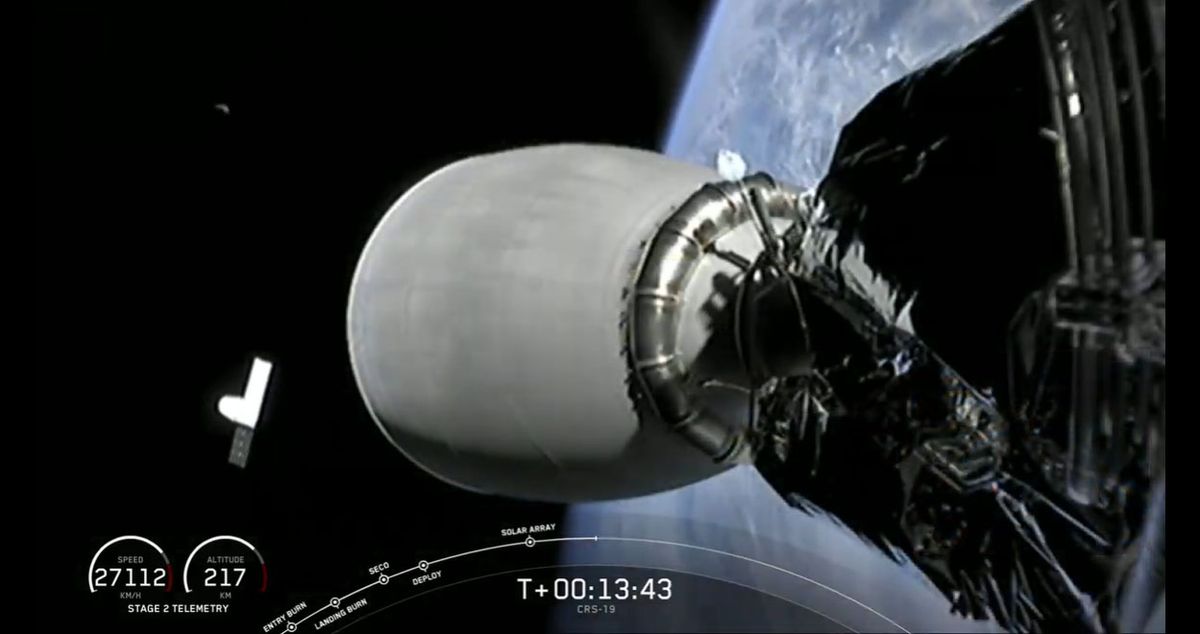SpaceX's Dragon CRS-19 spacecraft (bottom left) can be seen with its solar arrays unfurled in this view from a camera on the second stage of the Falcon 9 rocket that launched the Dragon earlier from Cape Canaveral Air Force Station in Florida.