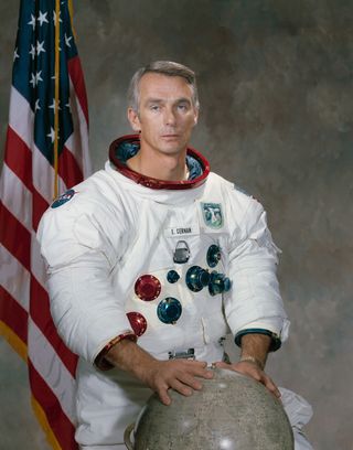 astronaut Eugene A. Cernan poses for his portrait with both hands on the globe.