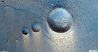 In this image, snapped March 22, 2021 by the CaSSIS camera on the ESA-Roscosmos ExoMars Trace Gas Orbiter (TGO), you can see a trio of Martian craters in the Lunae Planum region on the Red Planet. This area on Mars is covered in lava deposits from, scientists think, the nearby Tharsis Montes volcanoes. These three impact craters are surrounded by what appear to be much smaller impact craters.