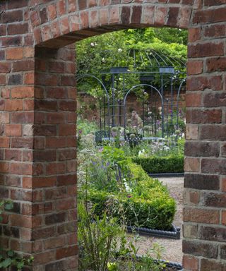 View through a doorway, from the kitchen garden into the formal parterre