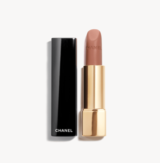 a tube of chanel lipstick in front of a plain backdrop