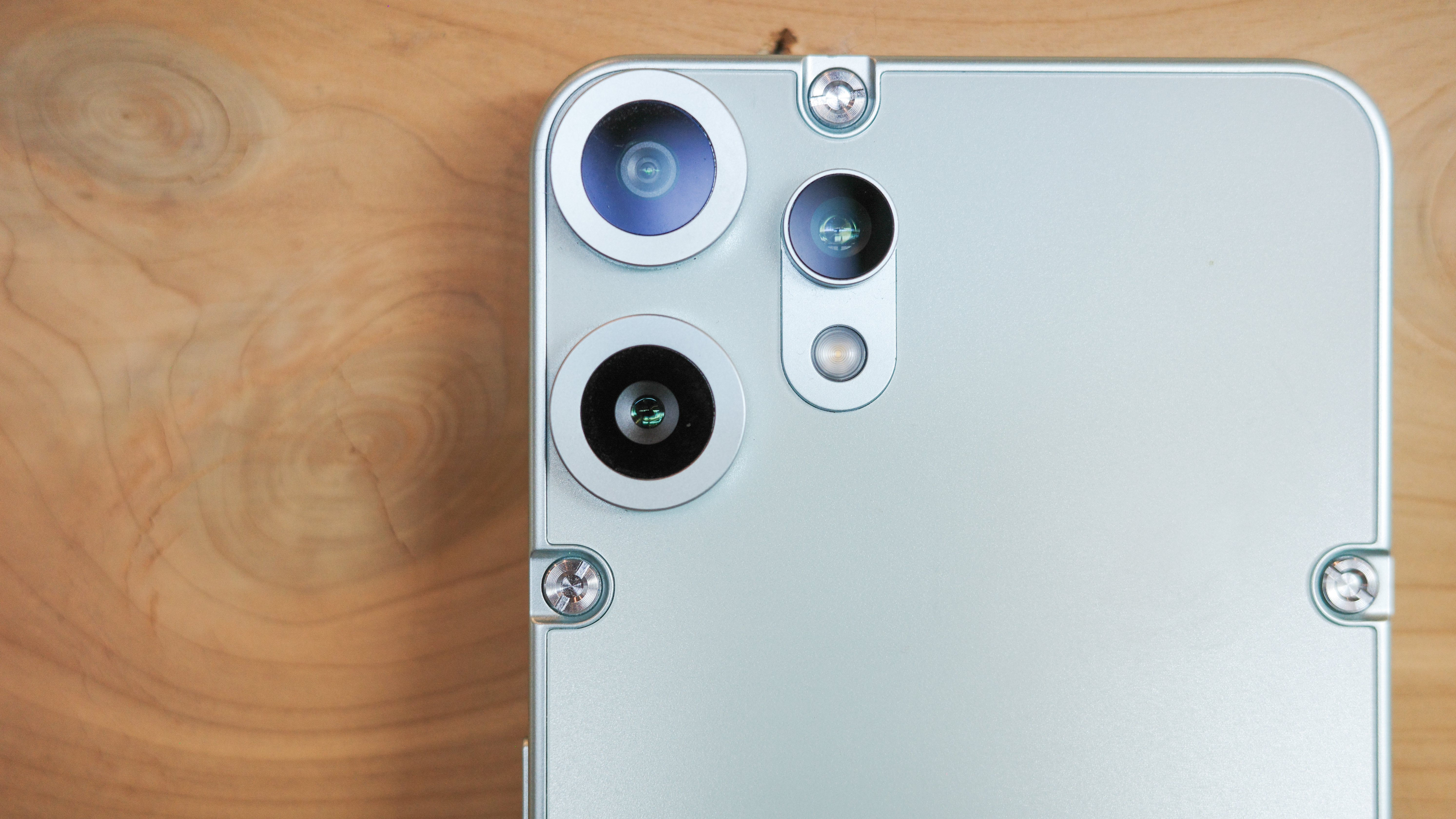 CMF Phone 2 Pro in light green showing back with exposed screws and cameras