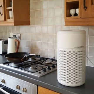 The Beko ATP5100I Air Purifier being tested by the side of a stainless steel gas hob in a kitchen