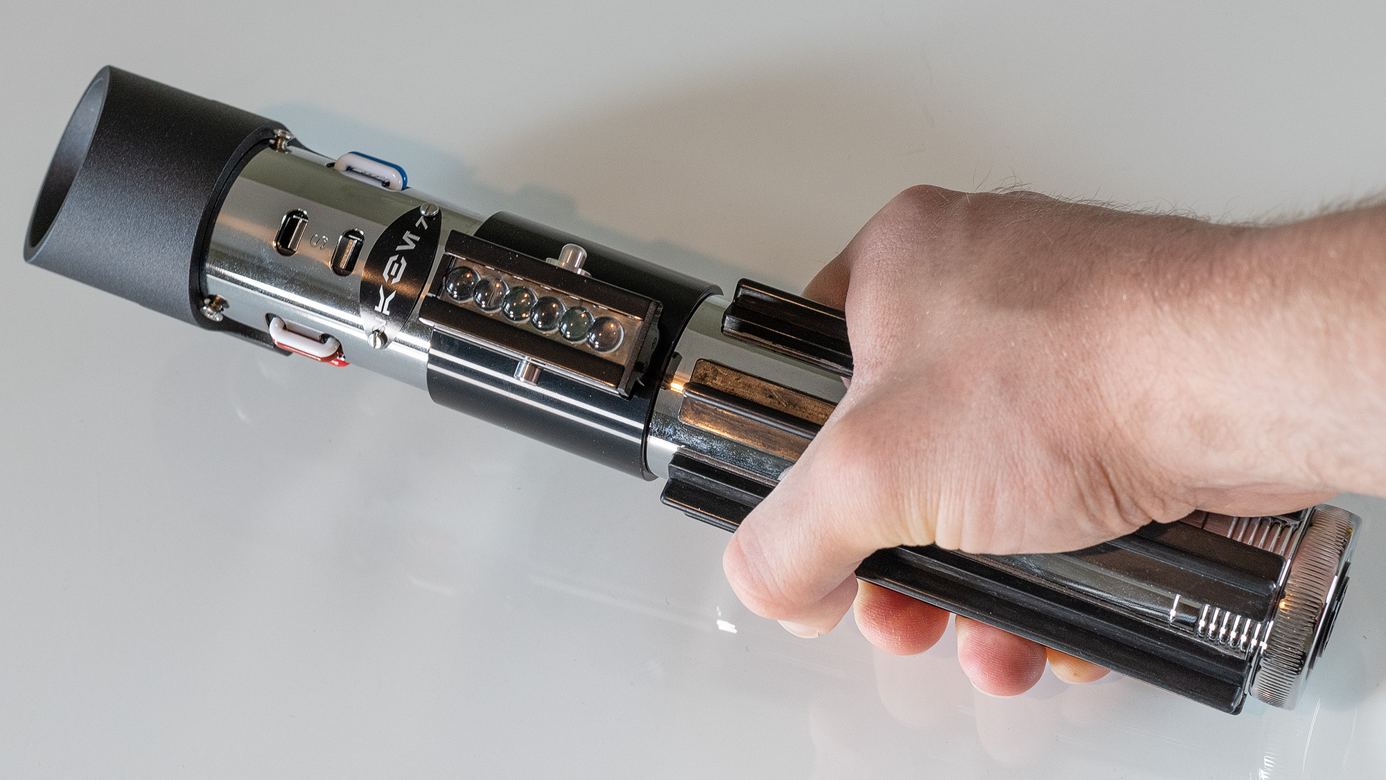 The SabersPro Vader lightsaber being held by the hand grip.