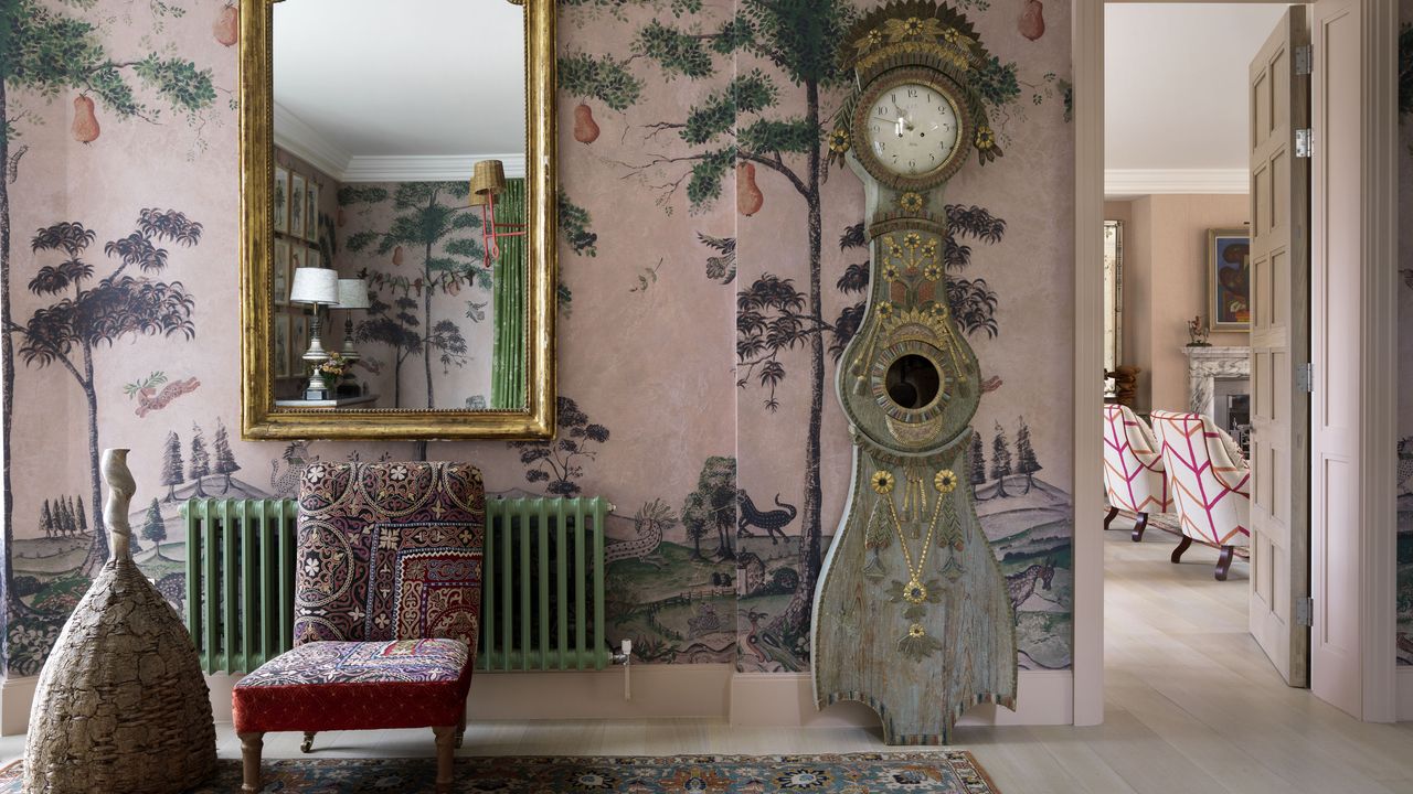 pink entrance hall with patterned wallpaper and Mora clock in Kit Kemp&#039;s London house