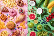 Healthy and unhealthy food background from fruits and vegetables vs fast food, sweets and pastry top view. Diet and detox against calorie and overweight lifestyle concept separated with measuring tape.