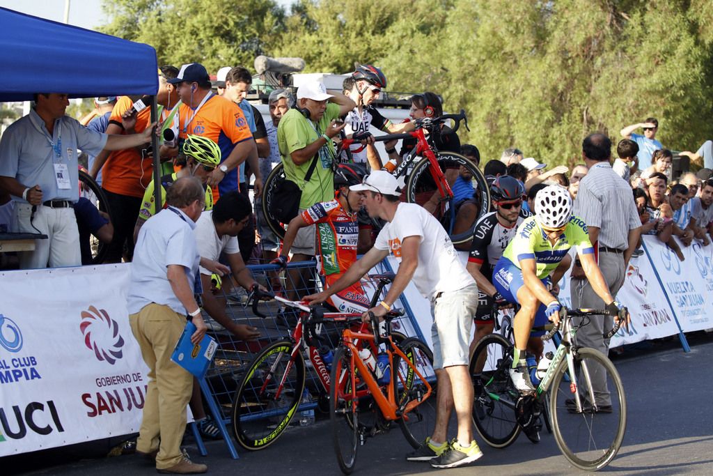 Officials help the riders over the barricades