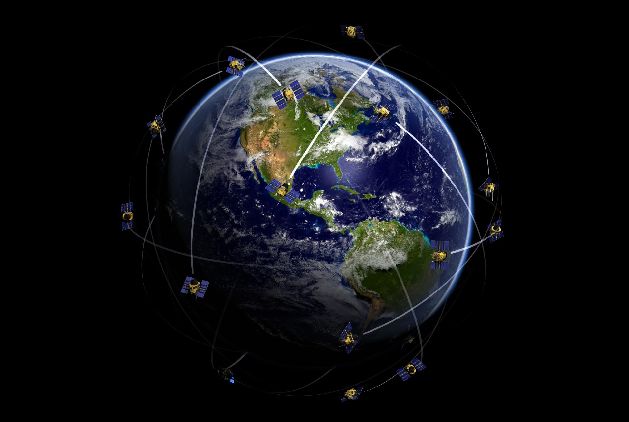 Graphic showing the path of GPS satellites around Earth at the center of the image.