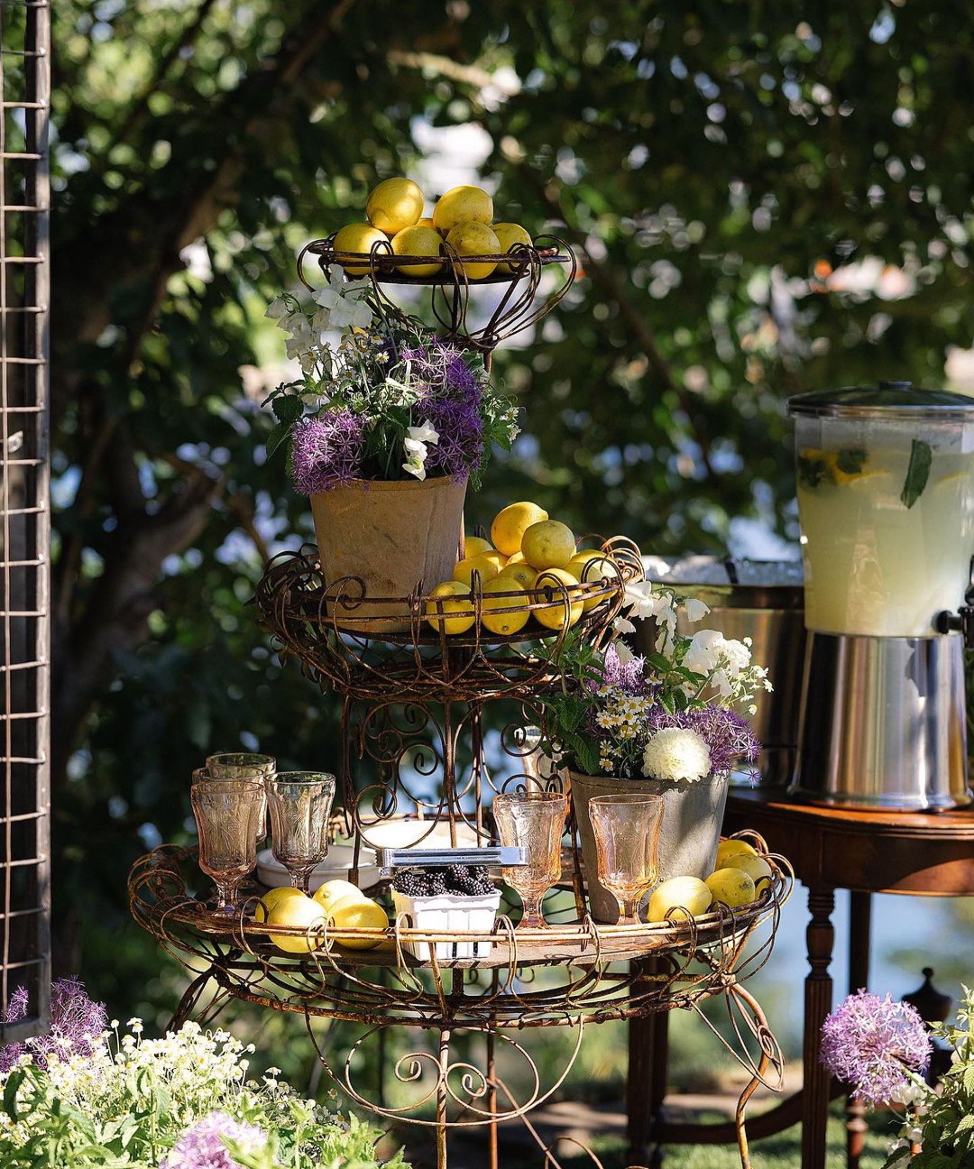 Lemonade drink stand with lemons and flowers on tiered wire rack