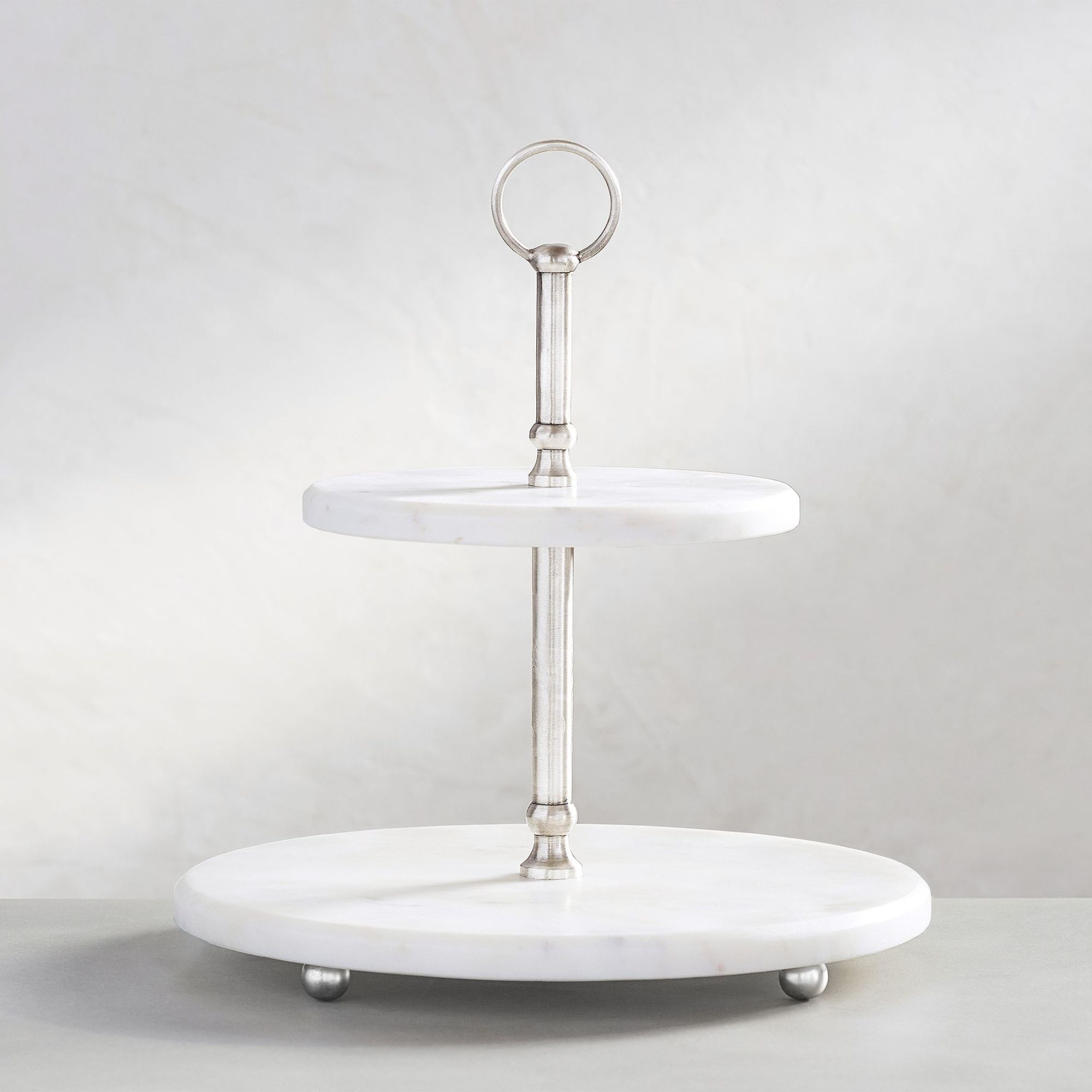 White marble two-tiered cake stand with aluminum rod