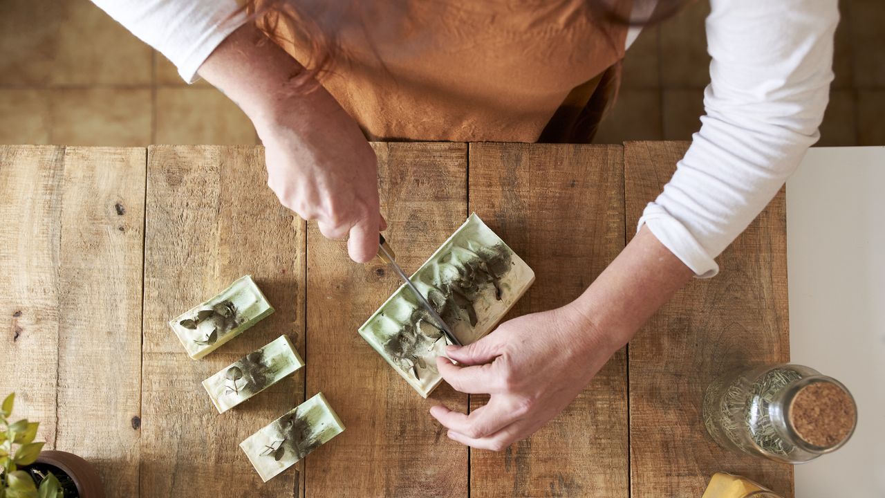 Woman cutting up a bar of soap