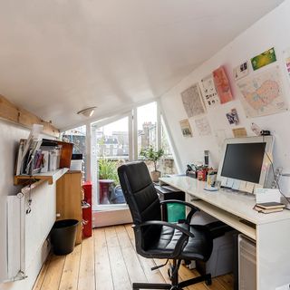 study room with wooden flooring and desktop computer with black chair