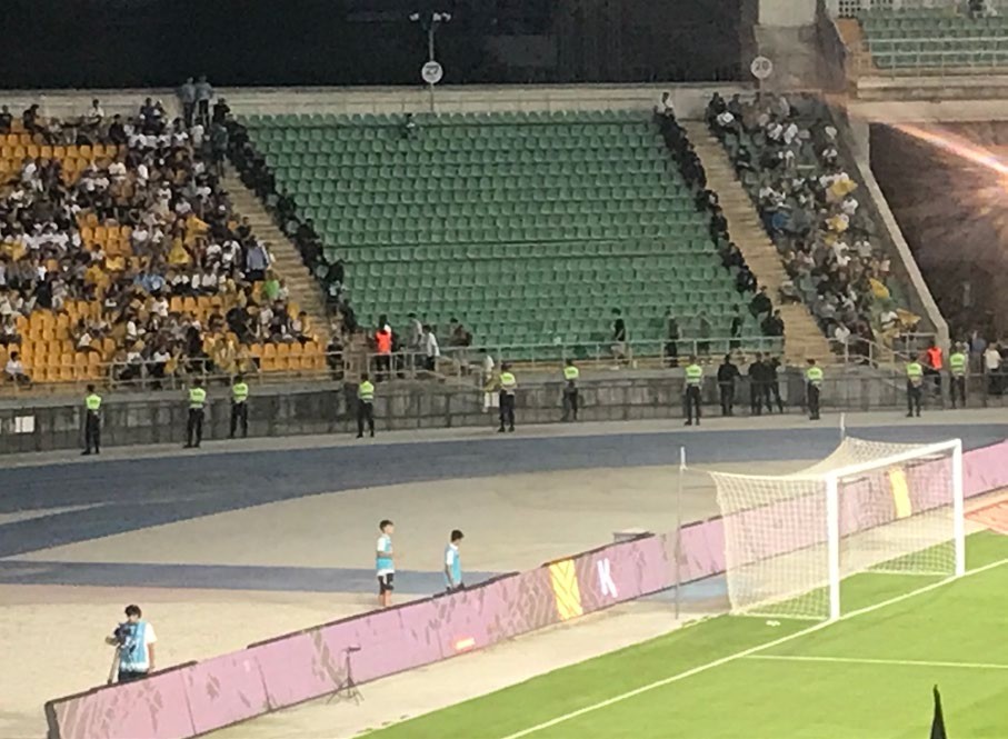 Policemen guard an away end holding just one Olimpija fan