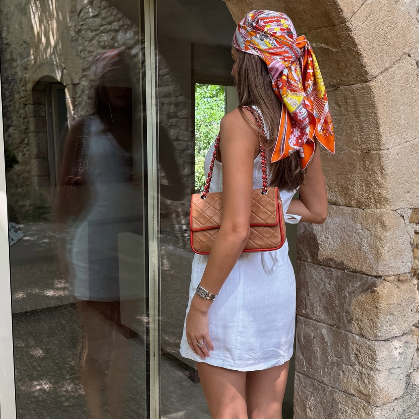 Sara Walker in a white Reformation linen dress